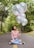 woman in gray scoop neck shirt holding balloons