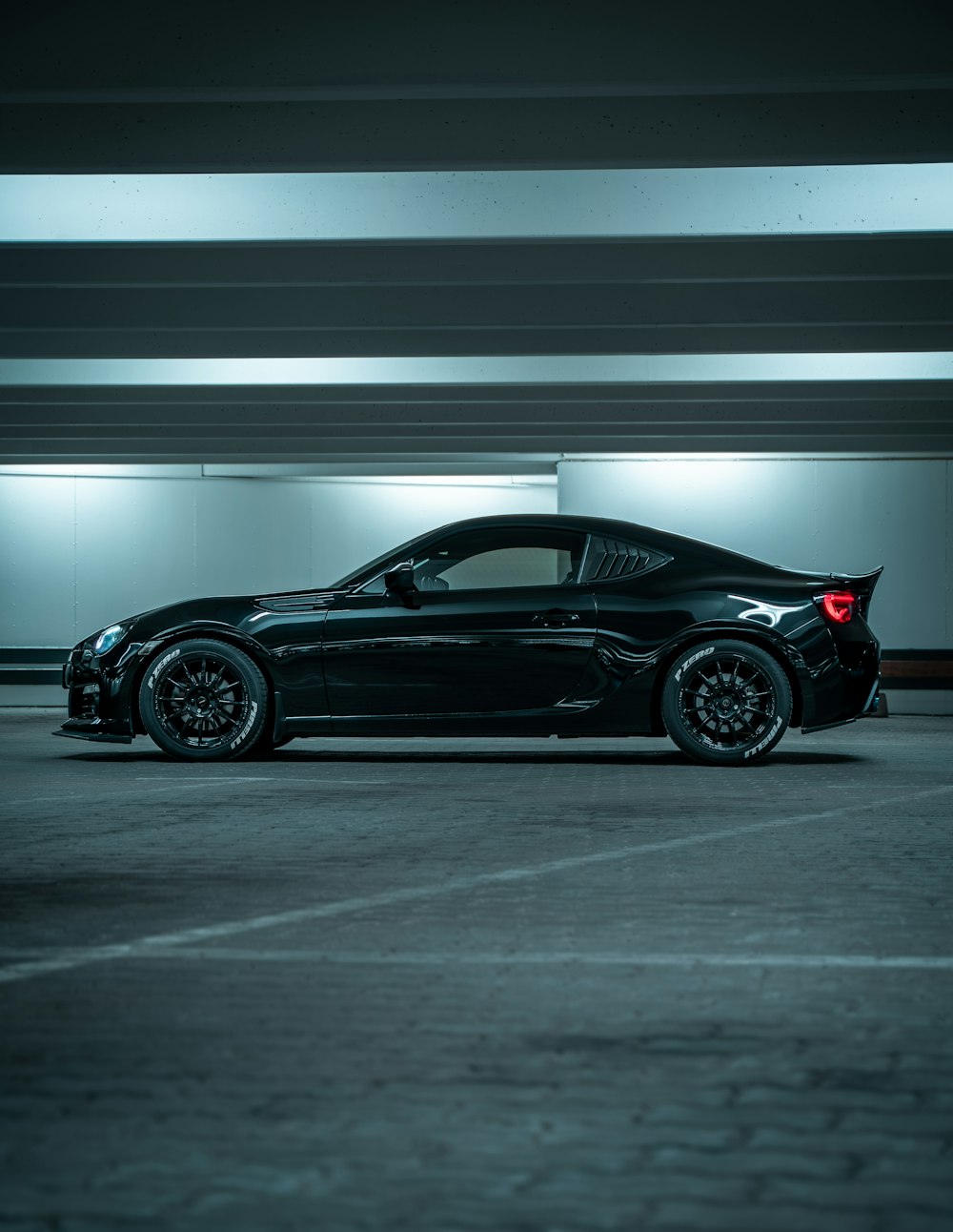 black porsche 911 parked in a parking lot