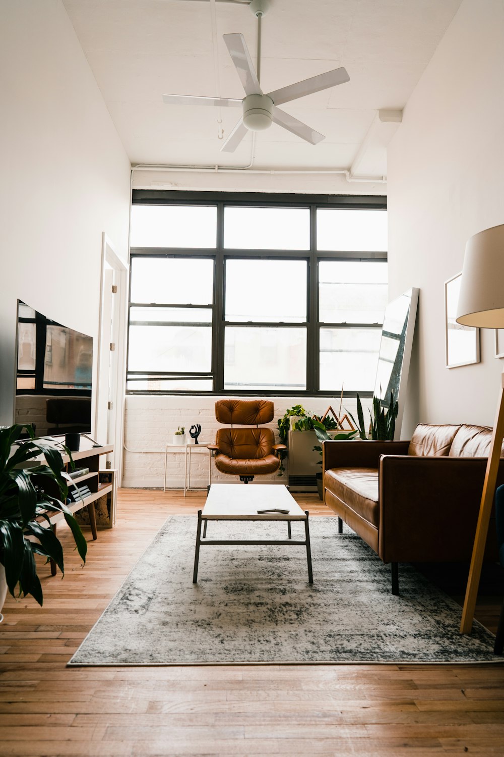 brown wooden table with chairs near window