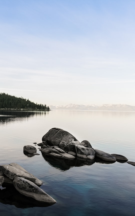 gray rocks on body of water during daytime in Lake Tahoe United States