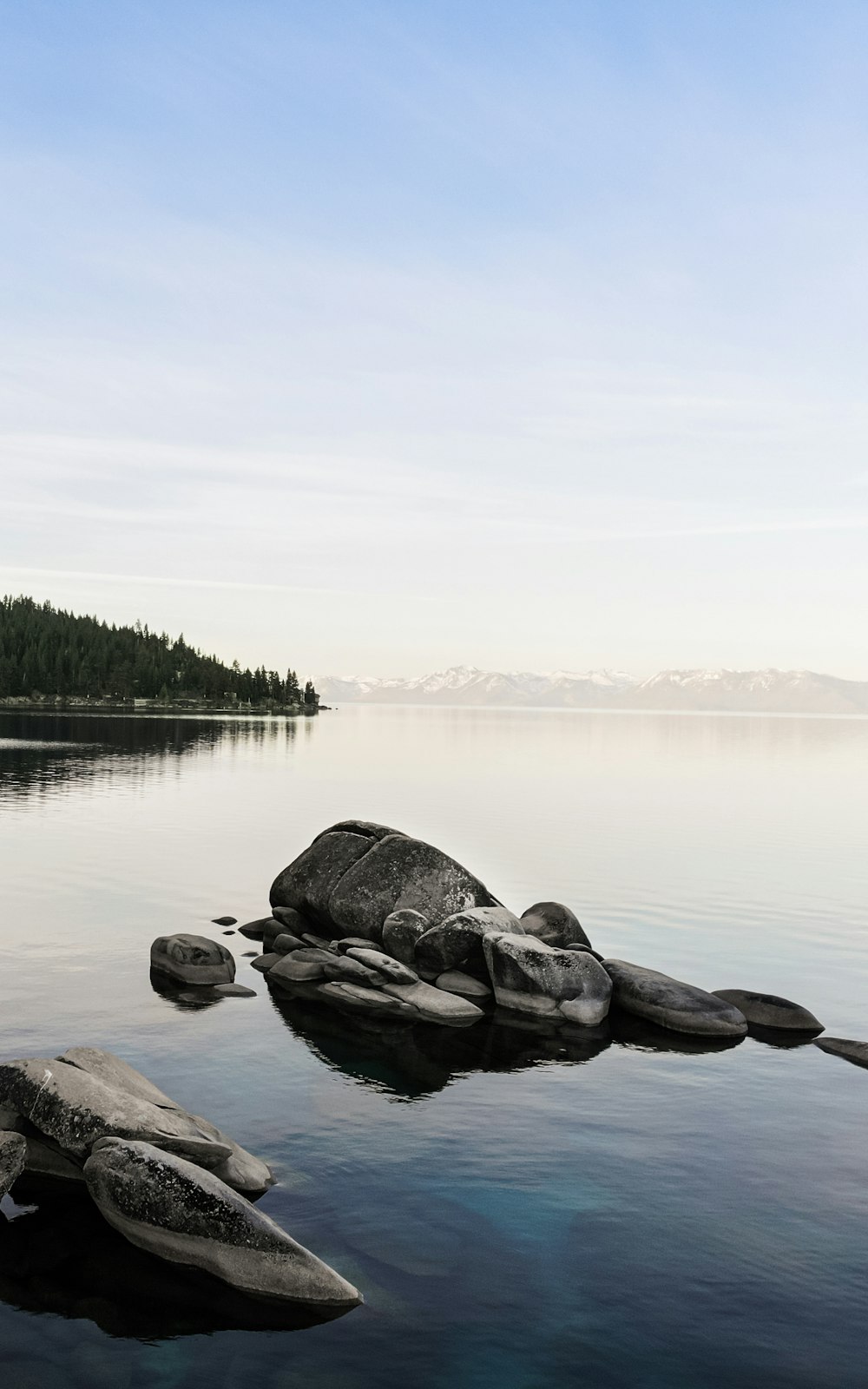 gray rocks on body of water during daytime