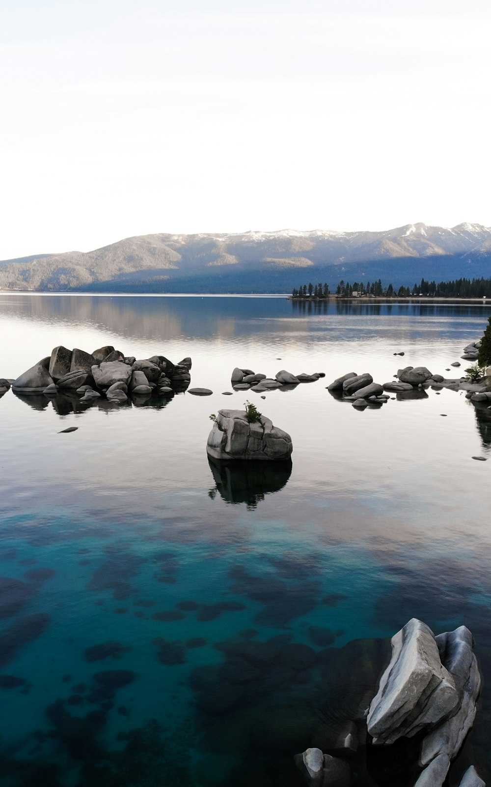 body of water near mountain during daytime