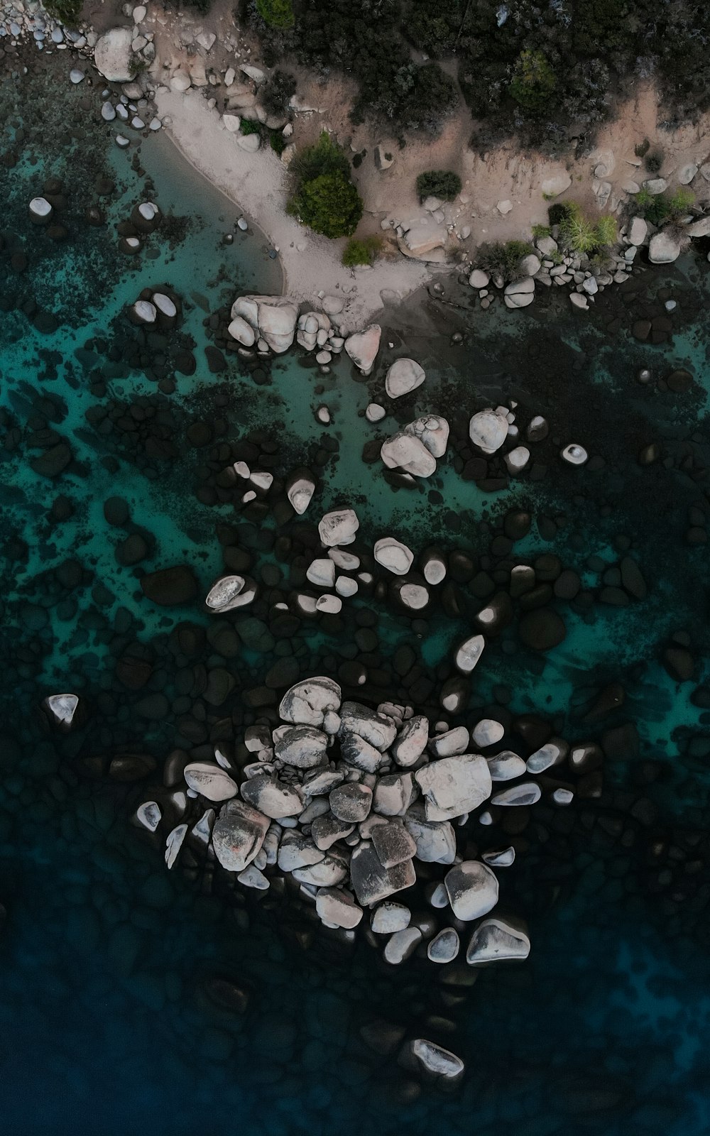 white and black stones on body of water