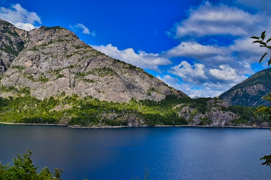 green and gray mountain beside blue lake under blue sky during daytime in Parque Nacional Nahuel Huapi Argentina