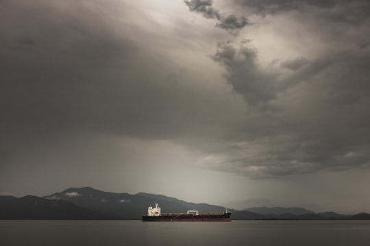 red and white ship on sea under cloudy sky during daytime in Paranaguá Brasil