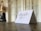 Close-up of a handwritten thank you note with a pen on a wooden desk.