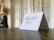 Close-up of hands exchanging a thank you note in a bright, welcoming environment.