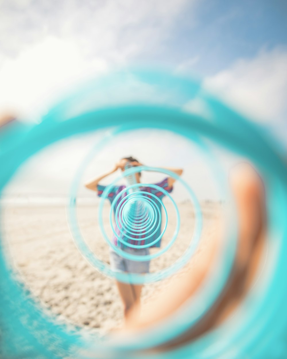 woman in white and blue dress standing on beach during daytime