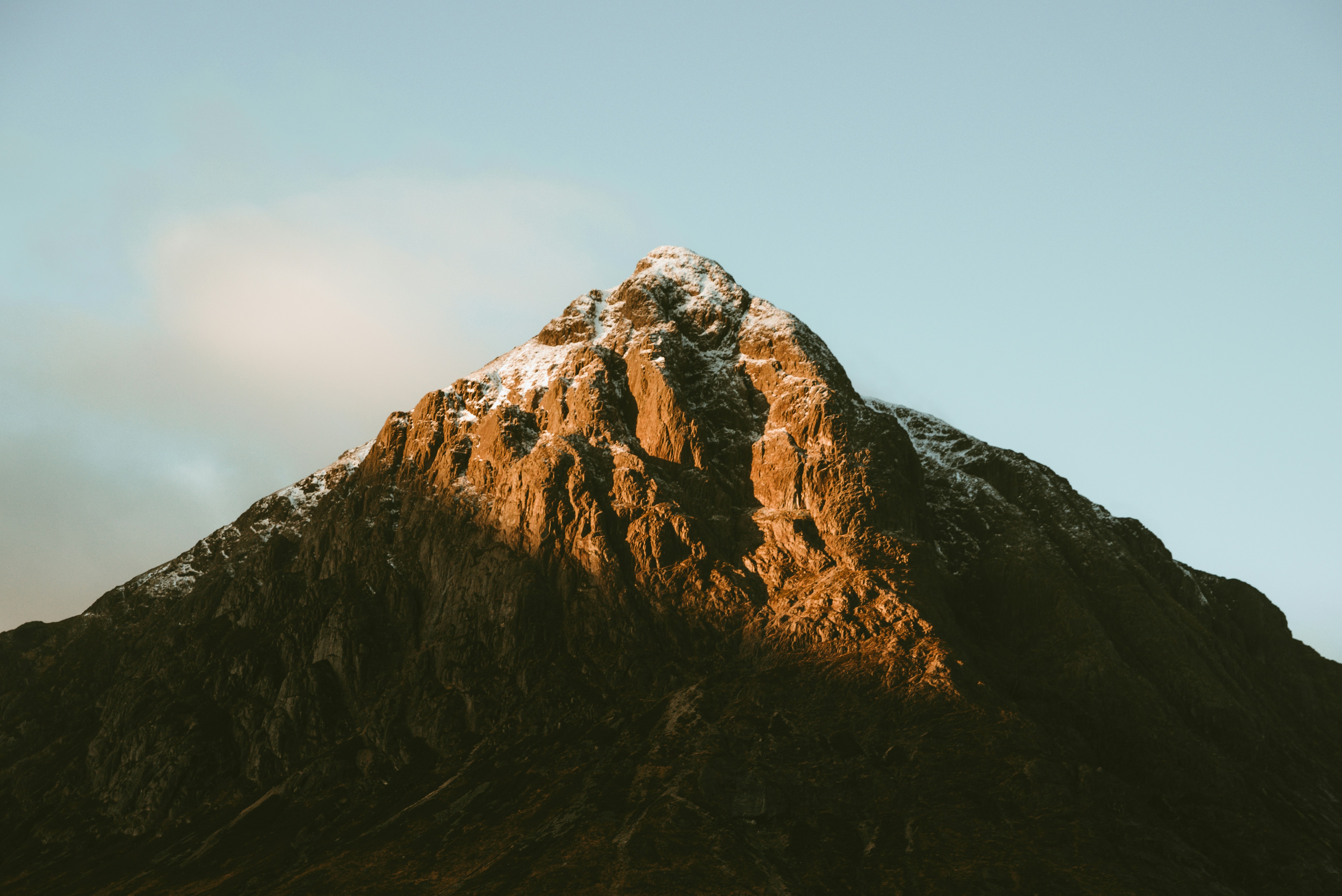 brown rocky mountain under blue sky during daytime