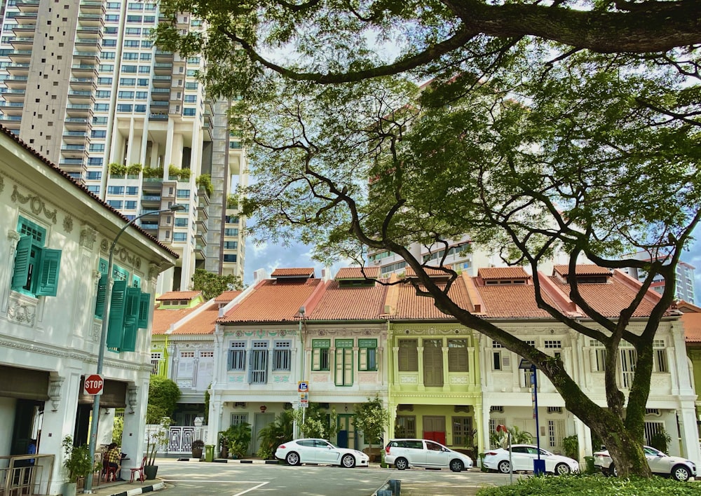 cars parked in front of brown concrete building during daytime