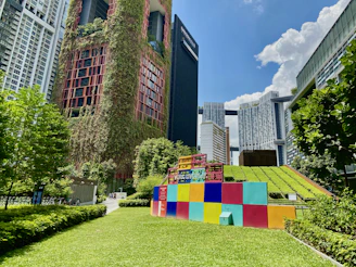 brown concrete building with green grass lawn