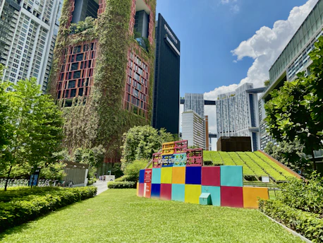 brown concrete building with green grass lawn
