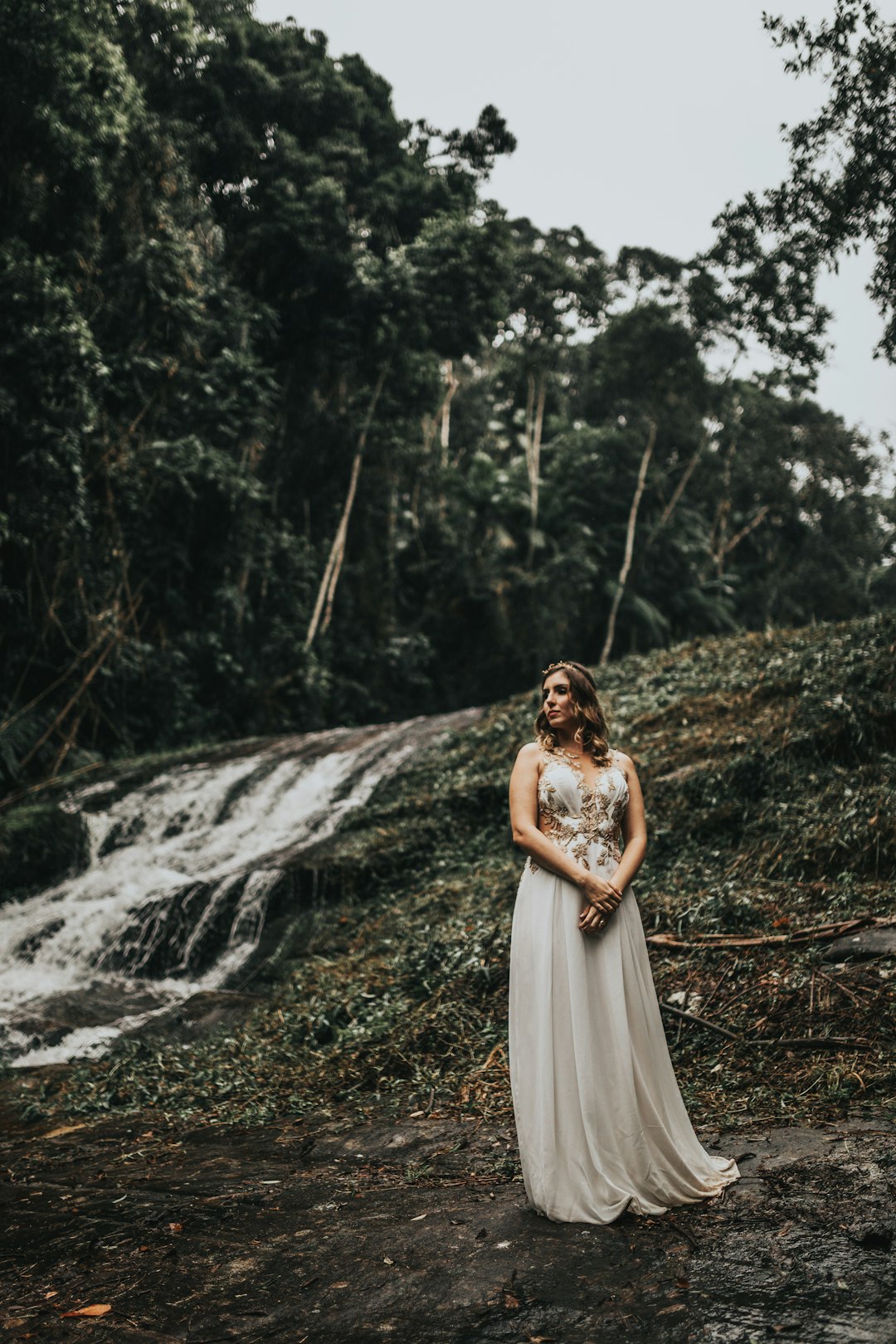 woman in white wedding dress standing on green grass field during daytime