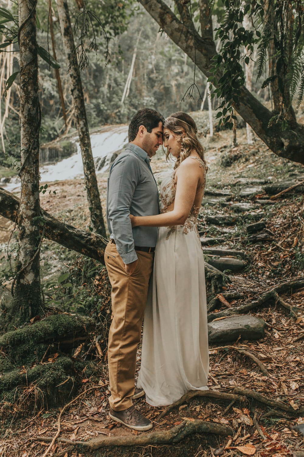 man and woman kissing near tree during daytime