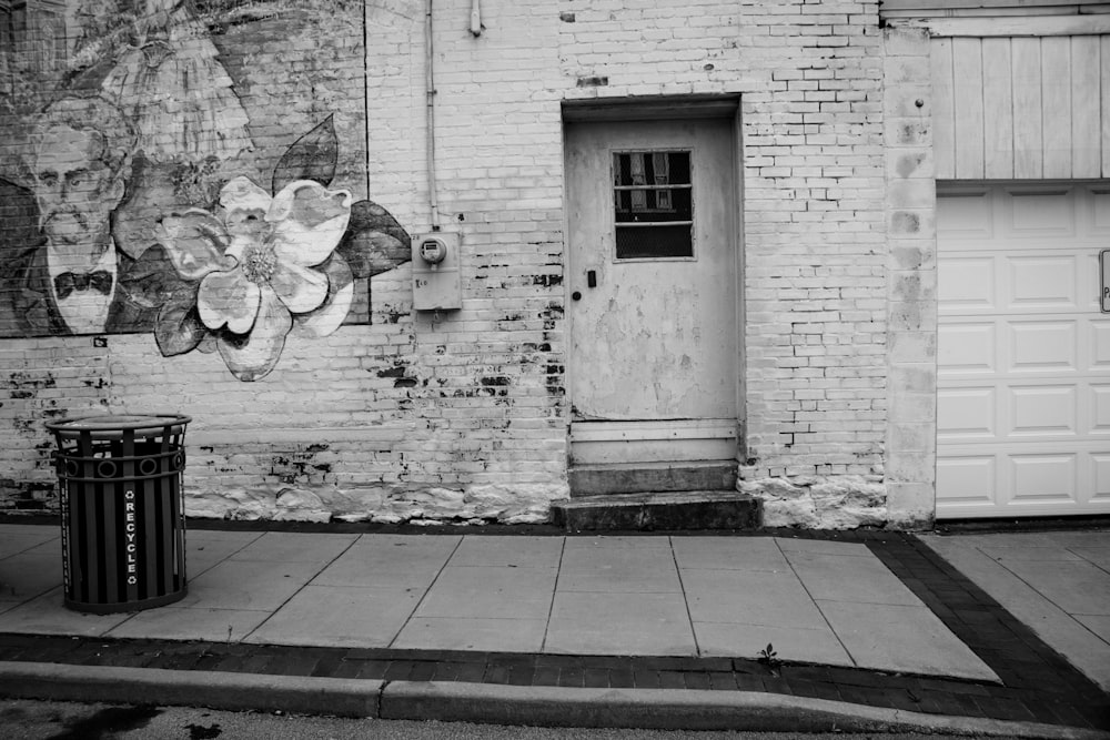 grayscale photo of man and woman kissing