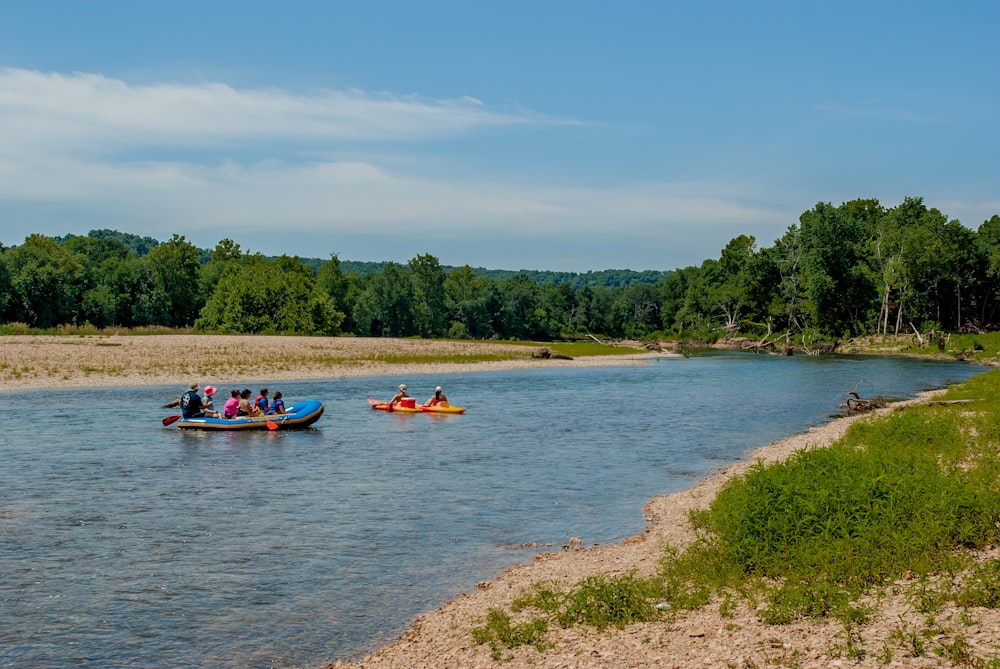 people riding on boat on river during daytime