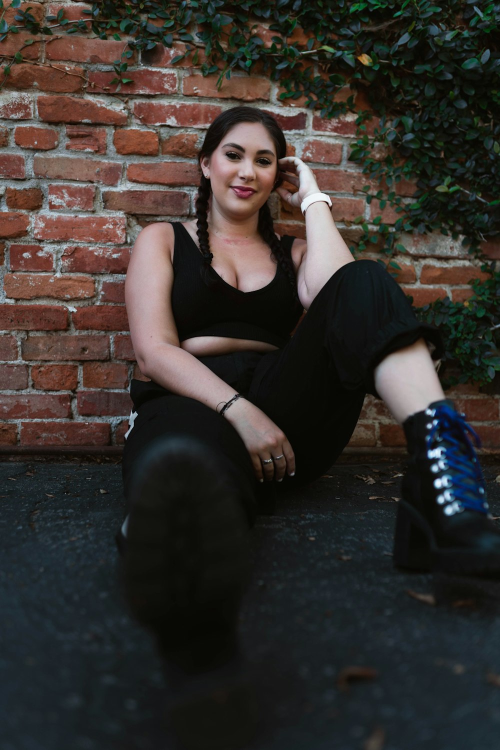 woman in black tank top and black pants sitting on floor