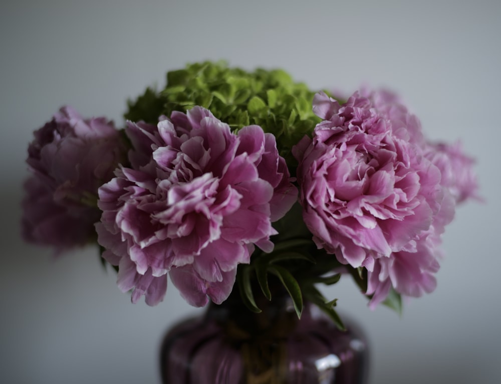 pink flowers in brown glass vase