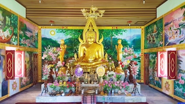 gold buddha statue on table