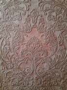 Artisan carefully embossing gold foil on a leather gift box.