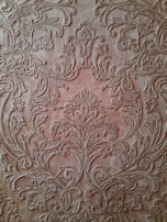 Artisan carefully embossing a leather surface on a gift box.