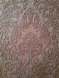 An elegant leather menu cover with intricate patterns.