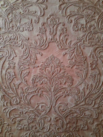 Artisan hands delicately applying a custom leather finish to a decorative support.