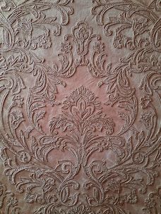 An elegant leather menu cover with intricate patterns.