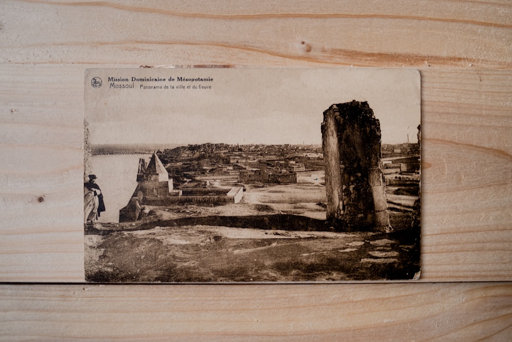 an old photo of a man standing on a cliff