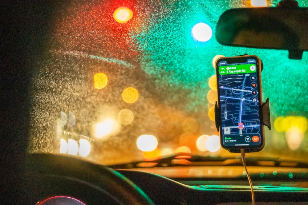 white smartphone on car dashboard