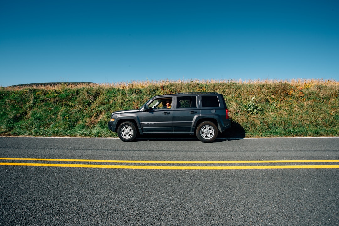 black suv on gray asphalt road during daytime