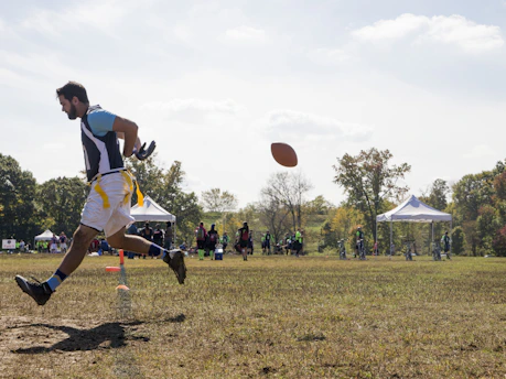 Athlete sprinting fiercely on a football field during a training session at impaktus.
