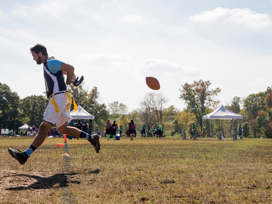 man in blue and white jersey shirt playing basketball during daytime