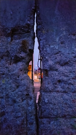 A close-up of a sturdy precast RCC compound wall under bright sunlight at a farm boundary.