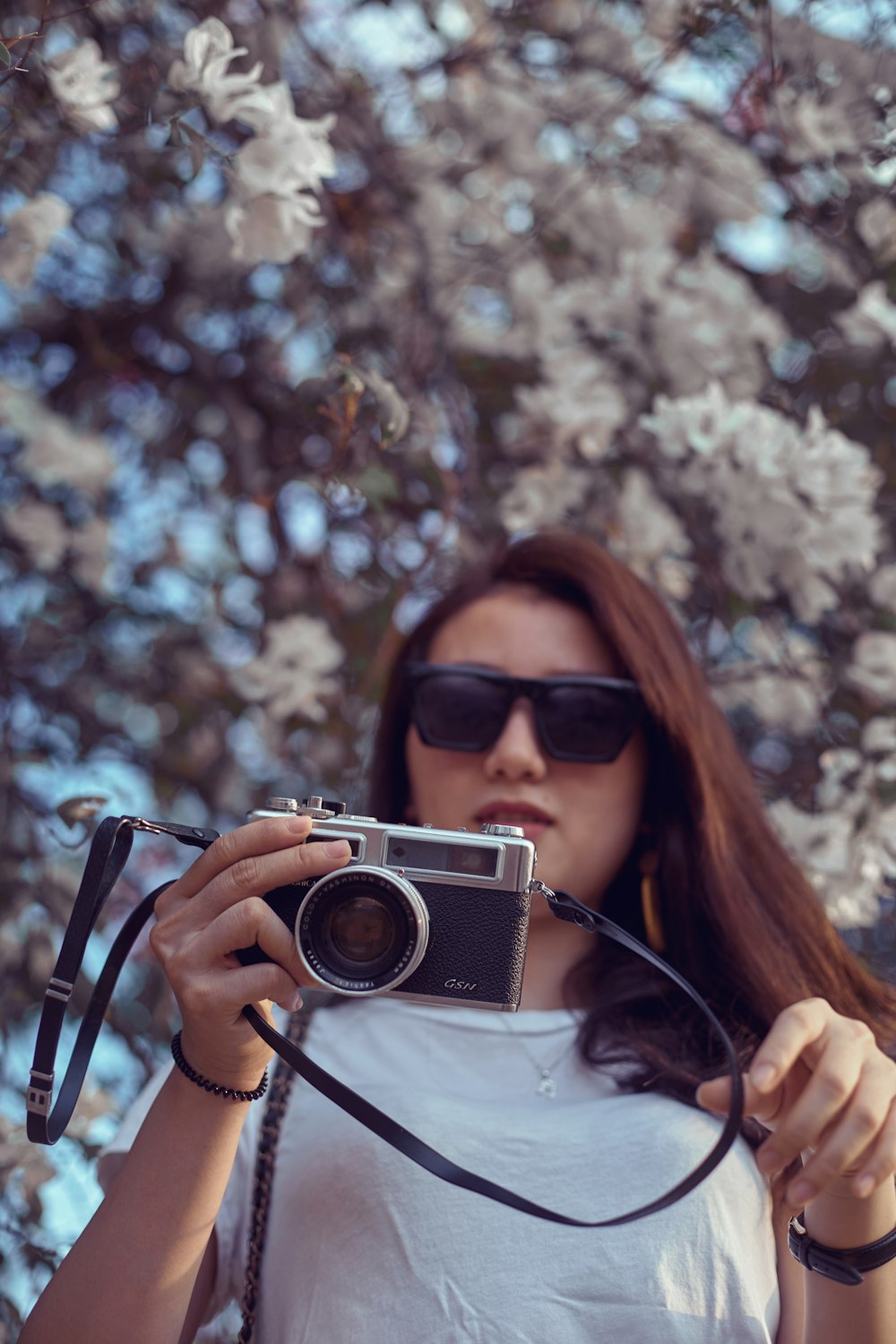 woman in black sunglasses holding camera