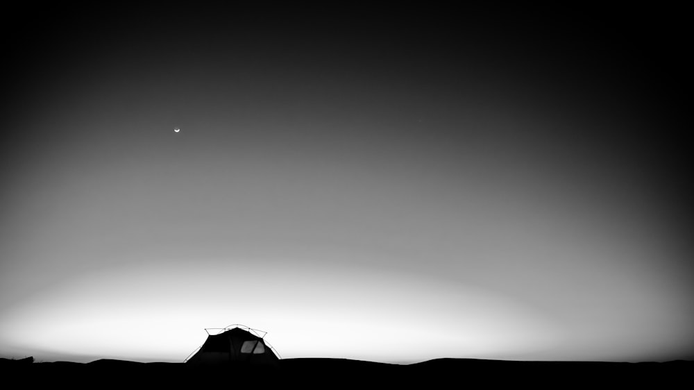 silhouette of house under gray sky