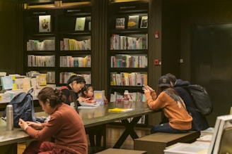 man in orange sweater sitting beside woman in blue sweater
