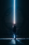 man in black jacket standing in tunnel