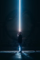 man in black jacket standing in tunnel