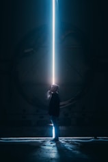 man in black jacket standing in tunnel