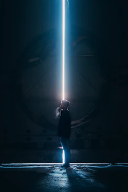 man in black jacket standing in tunnel