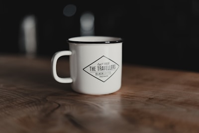 A sleek black mug with a custom logo design, ideal for corporate gifts or special events.