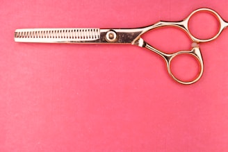 silver scissors on pink textile