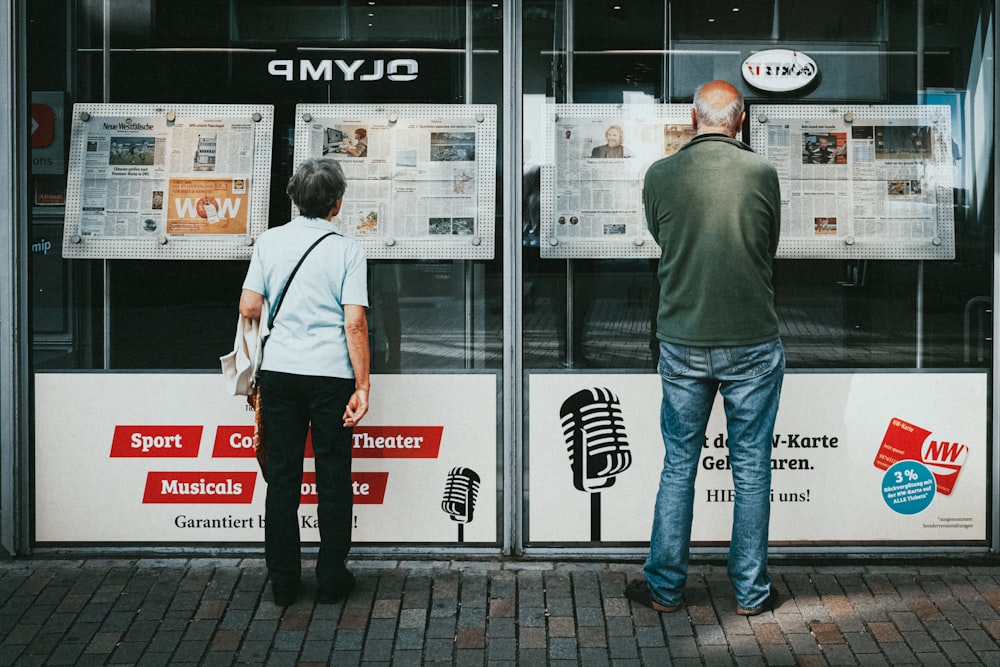 a couple of people standing outside of a building