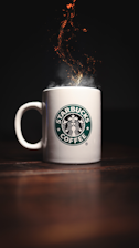 white starbucks ceramic mug on brown wooden table