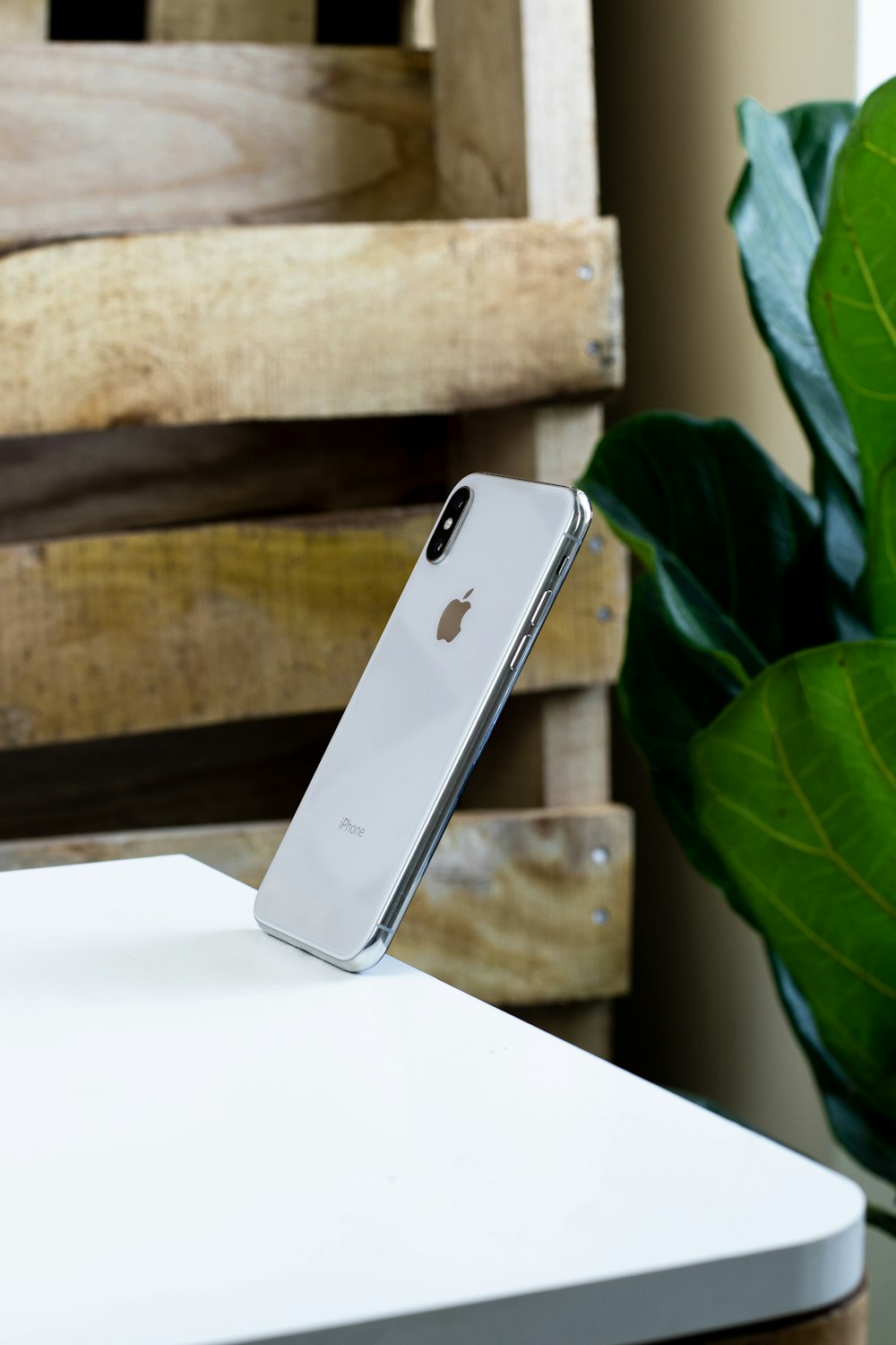 silver iphone 6 on white table