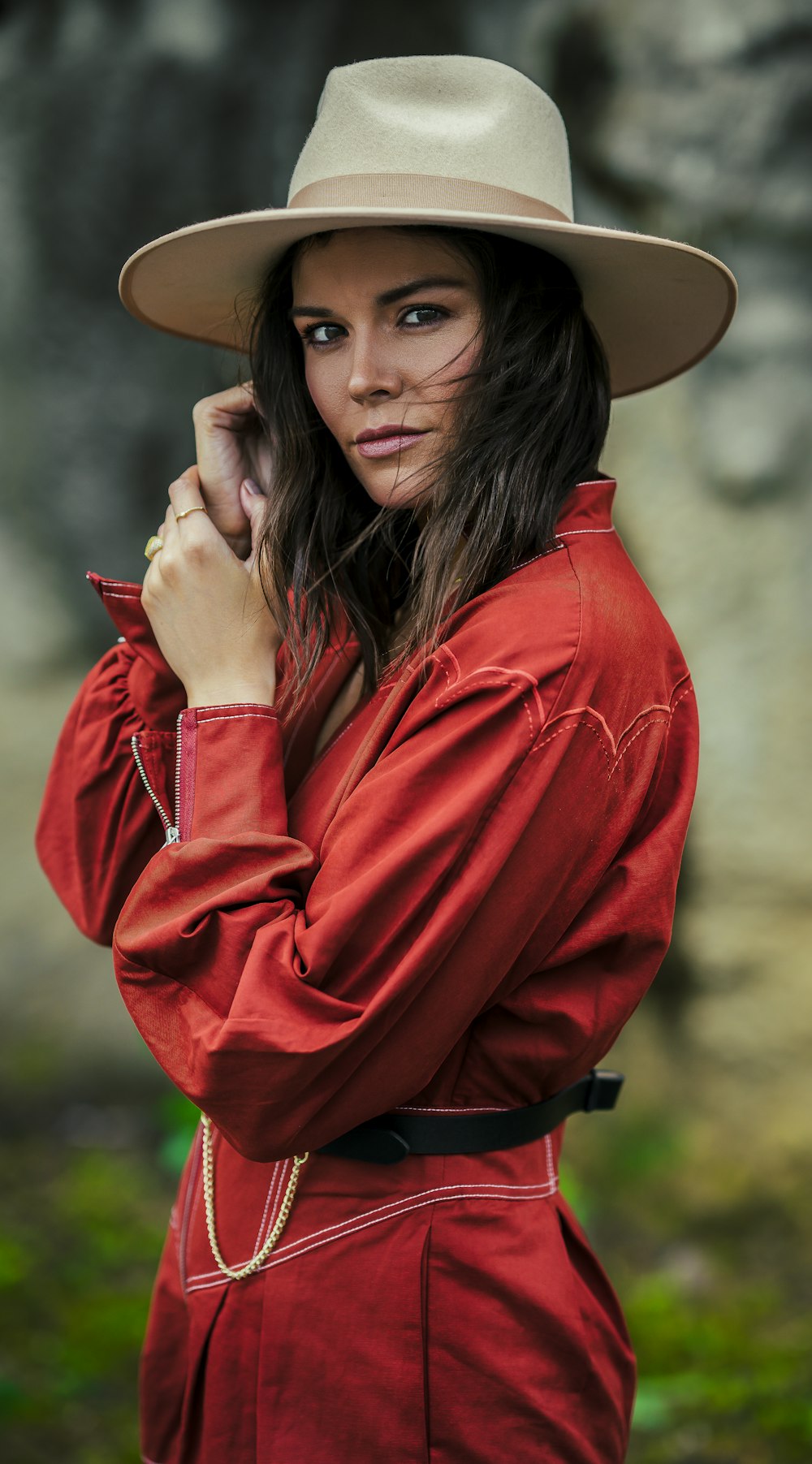 woman in red jacket wearing brown hat