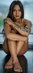 woman with black floral tattoo on her back