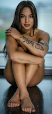 woman with black floral tattoo on her back