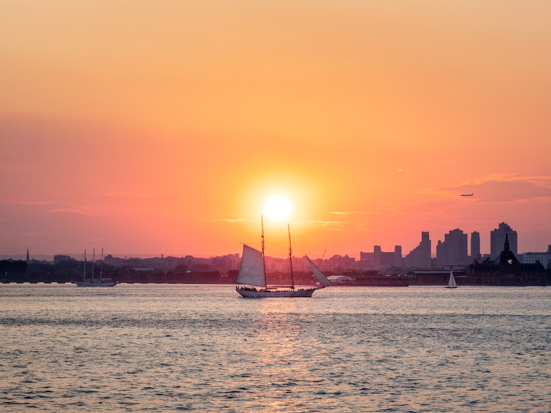 silhouette of sailboat on sea during sunset